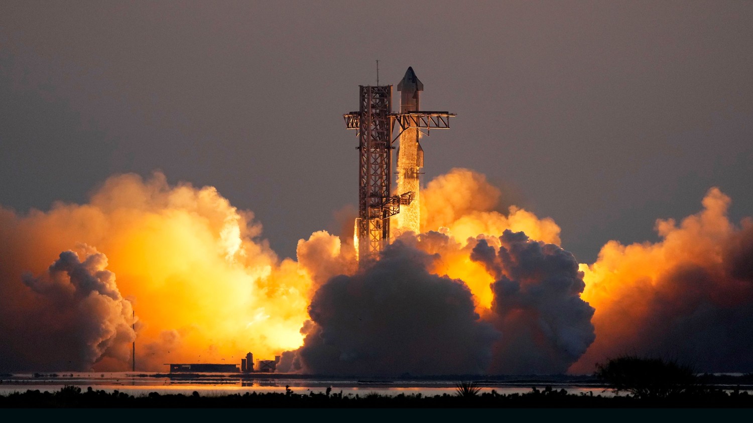 SpaceX's mega Starship rocket system lifts off from Starbase for a test flight on Sunday, in Boca Chica, Texas. Eric Gay/AP