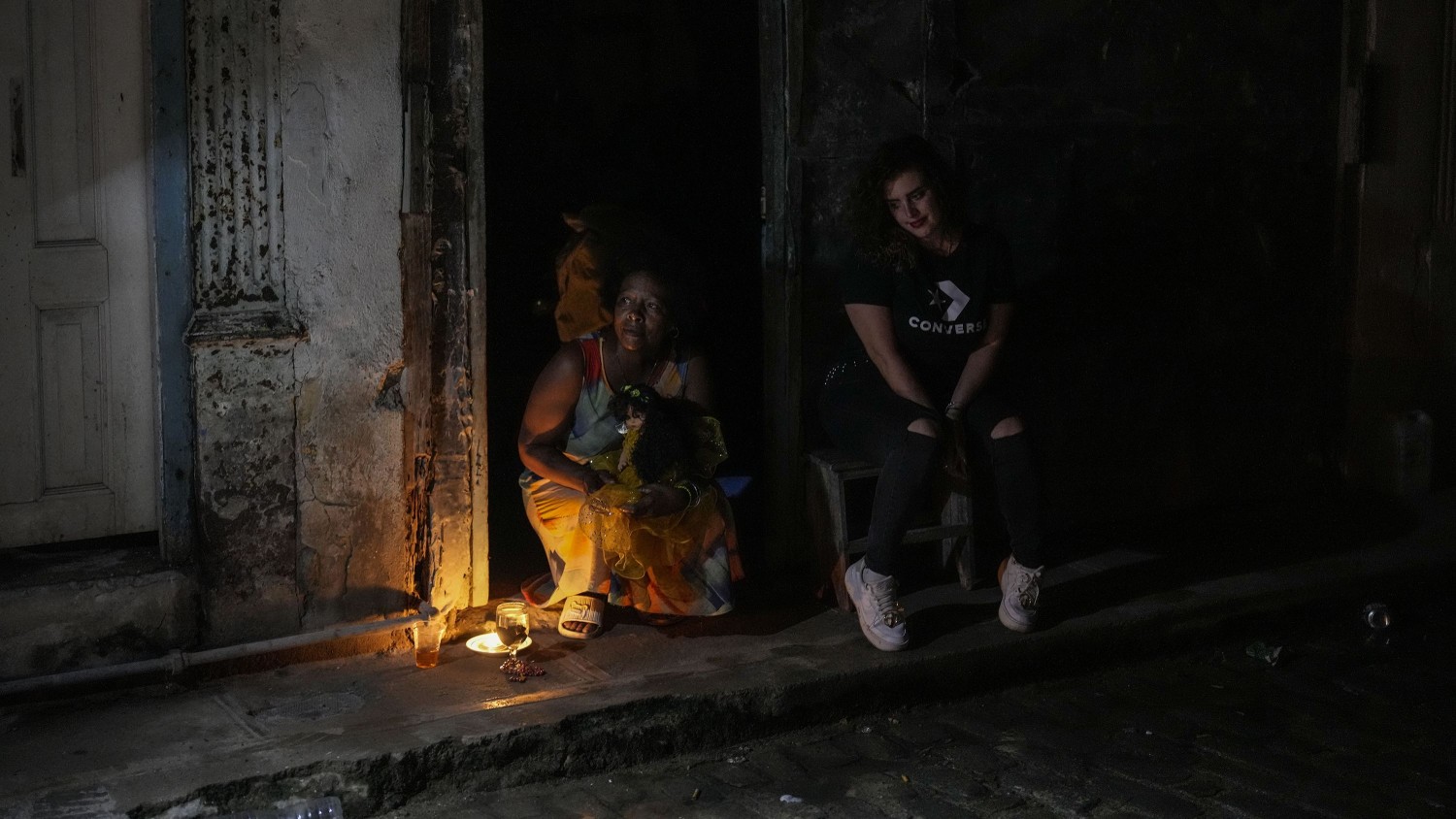 Residents pass the time during a blackout following the failure of a major power plant in Havana, Cuba on Saturday, Oct. 19, 2024. Ramon Espinosa/AP