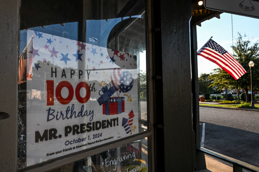 A sign celebrating former president Jimmy Carter’s 100th birthday is displayed in a shop window Monday in Plains, Ga. (Chandan Khanna/AFP/Getty Images)