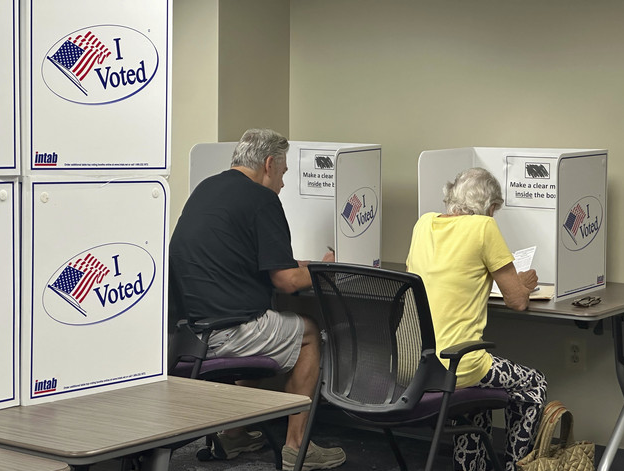 Voters cast their ballots on the first day of early voting on Sept. 20, 2024, in Alexandria, Virginia. | Nathan Ellgren/AP