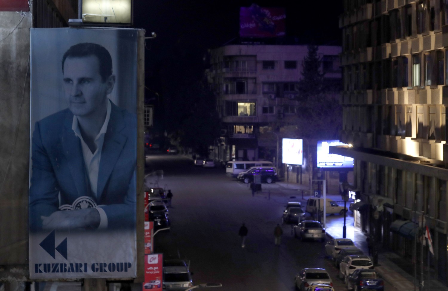 A portrait of Syrian President Bashar al-Assad is seen on a building in Damascus, Syria, on December 7. Omar Sanadiki/AP