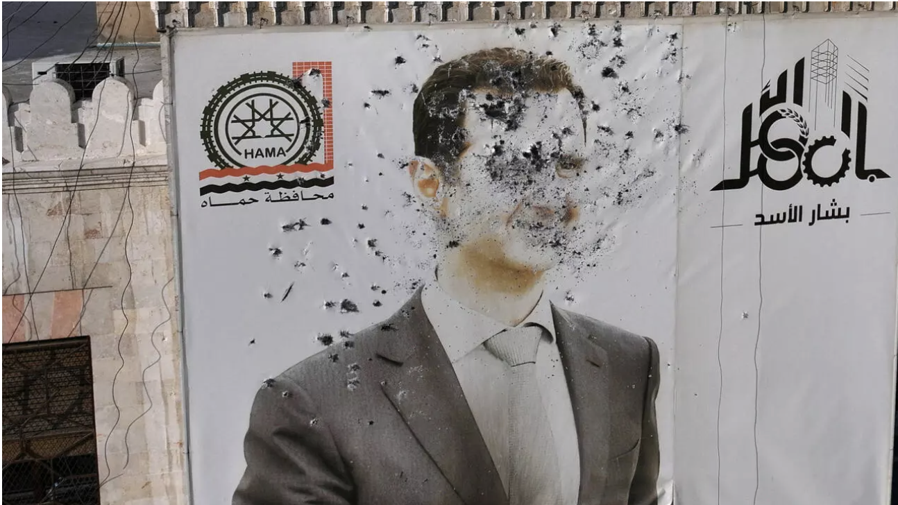 A bullet-riddled portrait of Syria's Bashar al-Assad adorns Hama's municipality following the city's capture by rebel forces on December 6, 2024. © Omar Haj Kadour, AFP