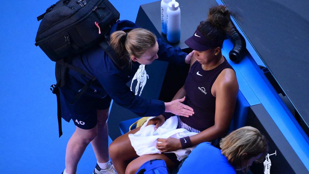 Naomi Osaka receives treatment late in the opening set against Bencic. (Photo by Yuichi YAMAZAKI / AFP)