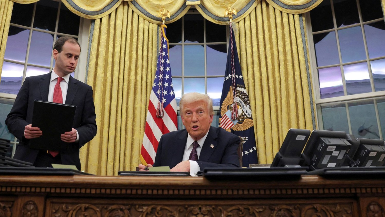 President Donald Trump speaks Monday as he issues executive orders and pardons from the Oval Office of the White House.  Carlos Barria/Reuters