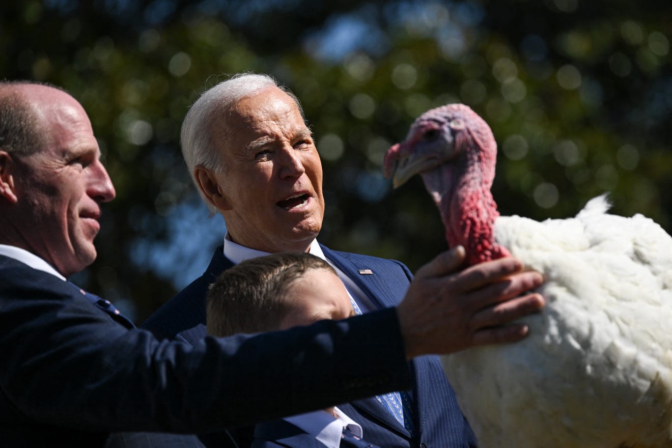 US President Joe Biden pardons Peach, the National Thanksgiving Turkey, alongside Chair of the National Turkey Federation John Zimmerman and his son Grant during an event on the South Lawn of the White House in Washington, DC, on Nov. 25, 2024.  DREW ANGE