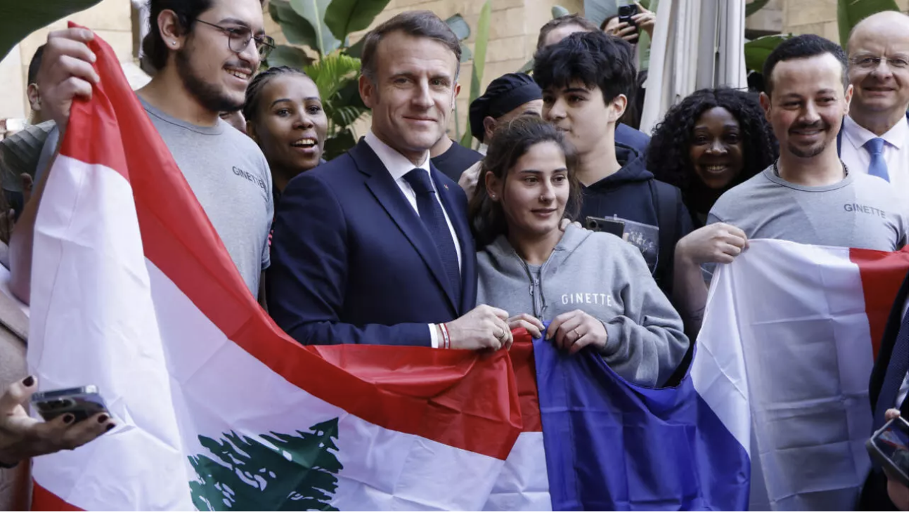 France's President Emmanuel Macron poses with Lebanese and a national flag during a visit at Beirut's Gemmayze district, on January 17, 2025. © Ludovic Marin