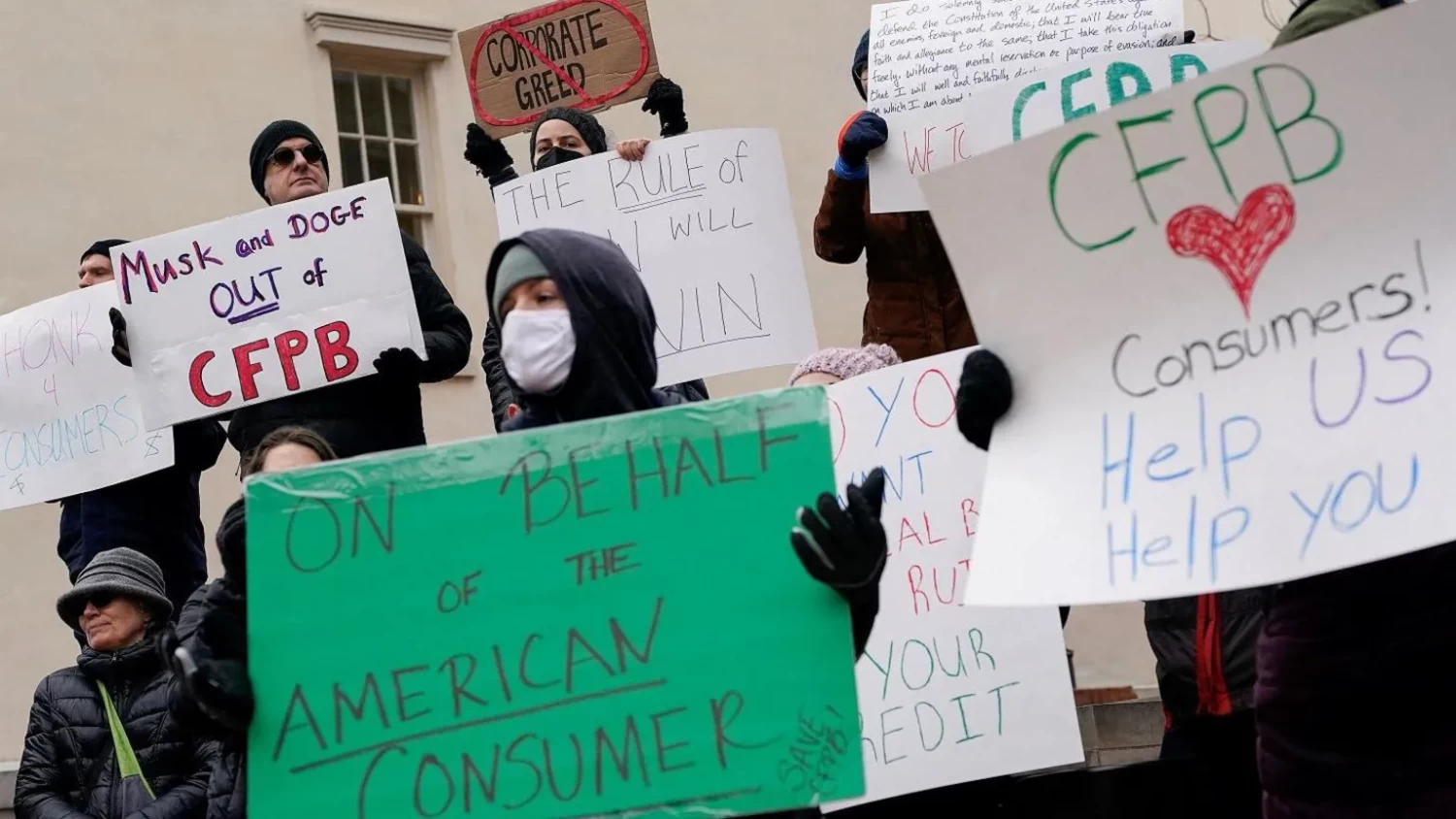 Reuters Demonstrators hold signs during a protest outside the Consumer Financial Protection Bureau on Saturday