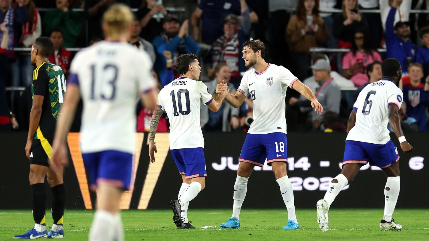 Christian Pulisic (No. 10) and Tanner Tessmann (No. 18) of the United States celebrate a goal during a November Concacaf Nations League quarterfinal match against Jamaica.  Jamie Squire/Getty Images