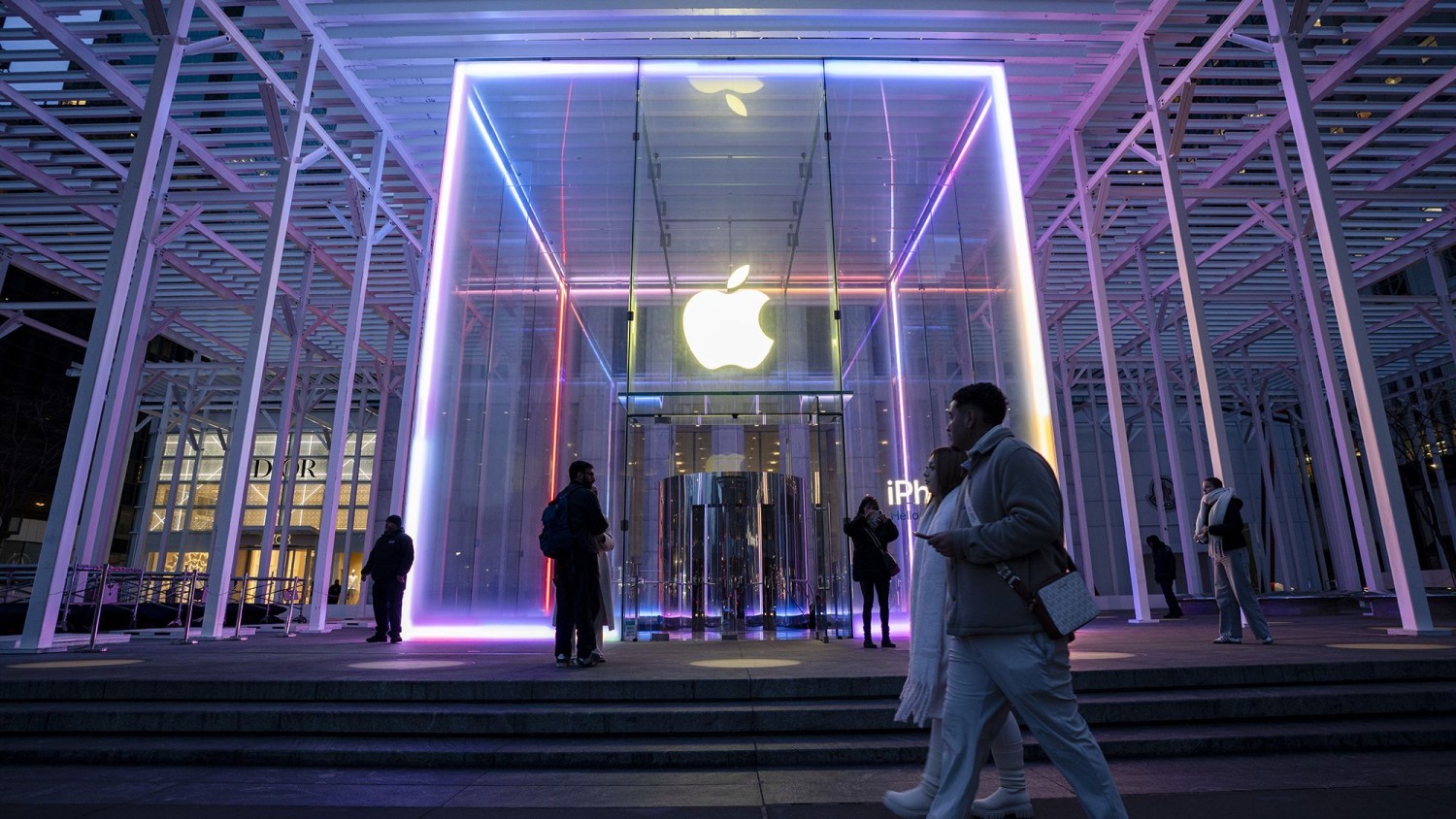 People walk by the Apple Store on Fifth Avenue during sunset on February 24, 2025 in New York City.  Craig T Fruchtman/Getty Images