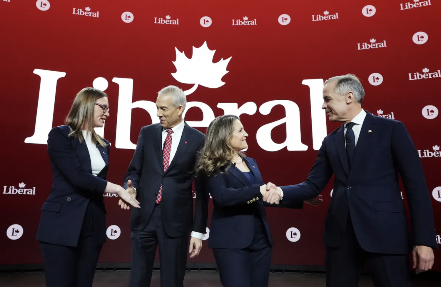 From left, Liberal Party of Canada leadership candidates Karina Gould, Frank Baylis, Chrystia Freeland and Mark Carney greet one another before a debate in Montreal on Feb. 25. (Christinne Muschi/The Canadian Press/AP)