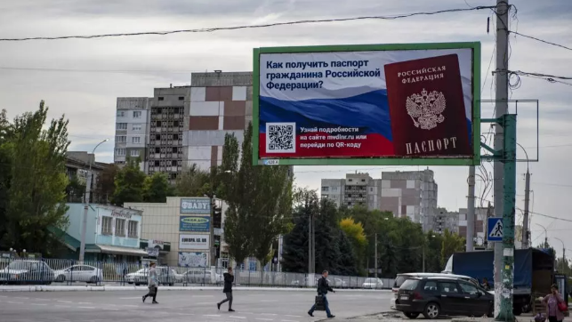 A billboard reading "How to get a passport of a citizen of Russia" in Luhansk People's Republic in eastern Ukraine, on September 22, 2022. AP