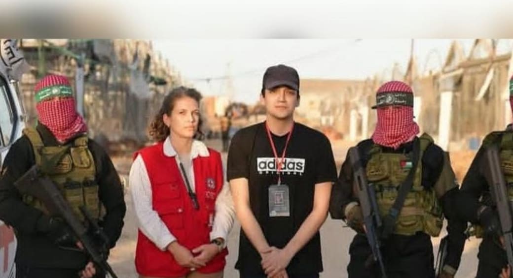 Israeli-American hostage Edan Alexander next to Hamas terrorists and a Red Cross employee, May 12, 2025. (photo credit: screenshot/Al Jazeera )