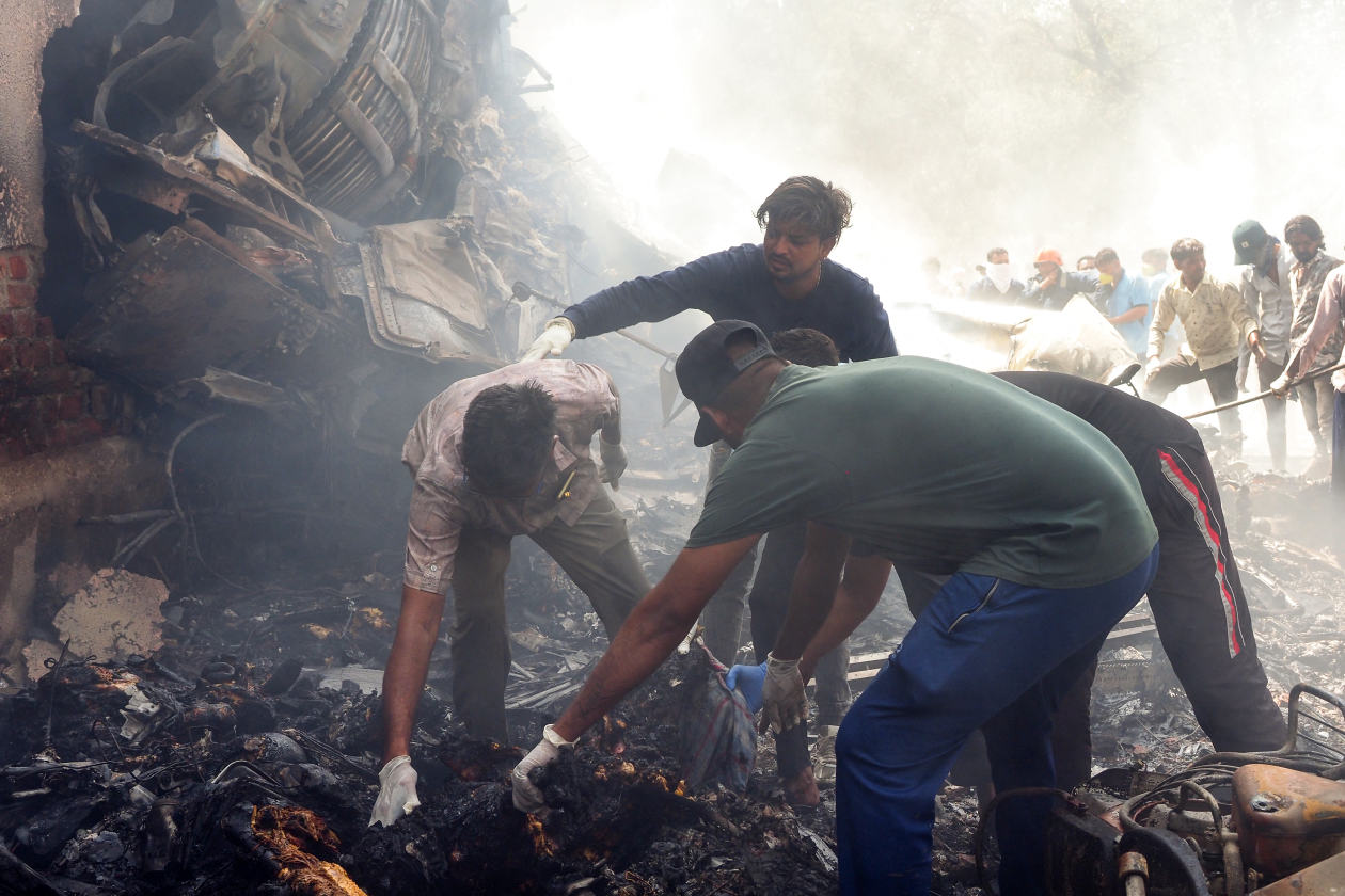 Rescue workers at the site of the Air India plane crash near the airport in Ahmedabad, India. Photo: Sam PANTHAKY/AFP/Getty Images