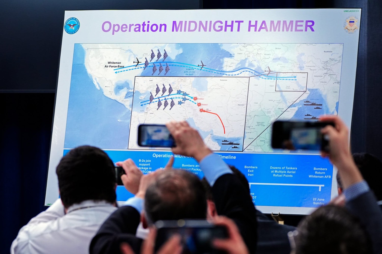 Reporters photographing a display for “Midnight Hammer,” the name of the American operation to bomb Iran’s nuclear sites, during a news conference on Sunday.Credit...Alex Brandon/Associated Press