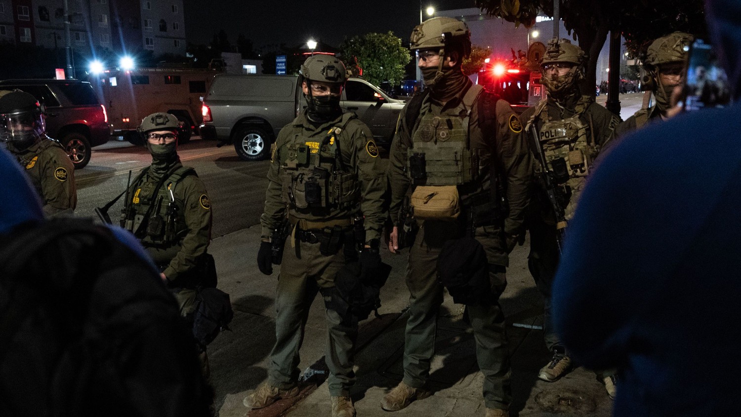 ICE officers form a barrier to block protesters after performing a raid in Chinatown on June 6 in Los Angeles, CA.  Luke Johnson/Los Angeles Times/Getty Images