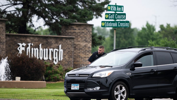A Brooklyn Park police officer speaks with the driver of a vehicle entering a neighborhood on June 14, 2025, in Brooklyn Park, Minnesota. ( Stephen Maturen/Getty Images)