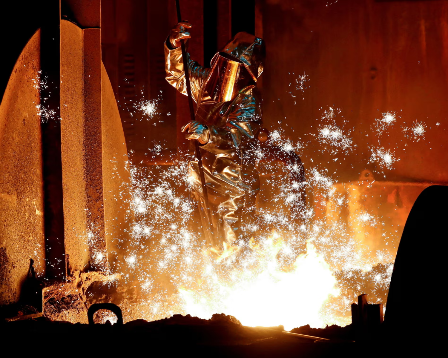 A steel worker takes a sample from a blast furnace at the ThyssenKrupp factory in Duisburg, Germany. Photograph: Wolfgang Rattay/Reuters