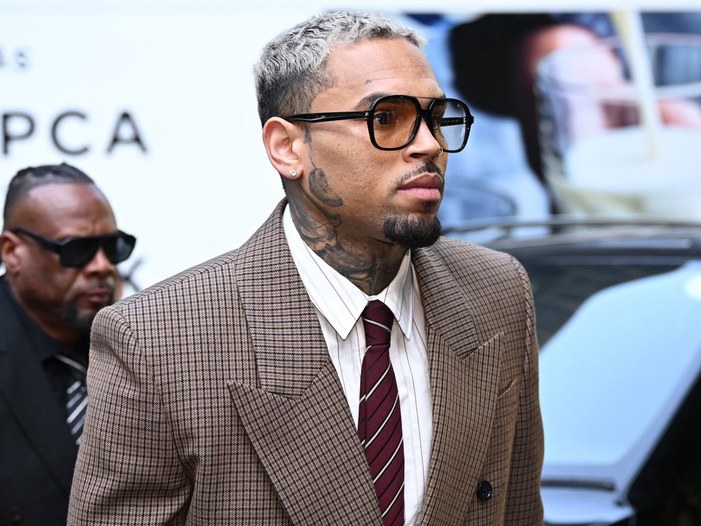 Chris Brown has arrived in court, accused of assaulting a music producer while flanked by a gaggle of adoring fans. Picture: Leon Neal/Getty Images