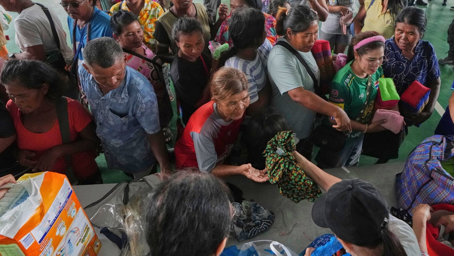 Aid is distributed to some of the thousands displaced in Thailand’s Surin province by fighting on the border with Cambodia © AP