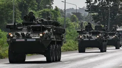 AFP via Getty Images Thailand's soldiers move in armoured vehicles