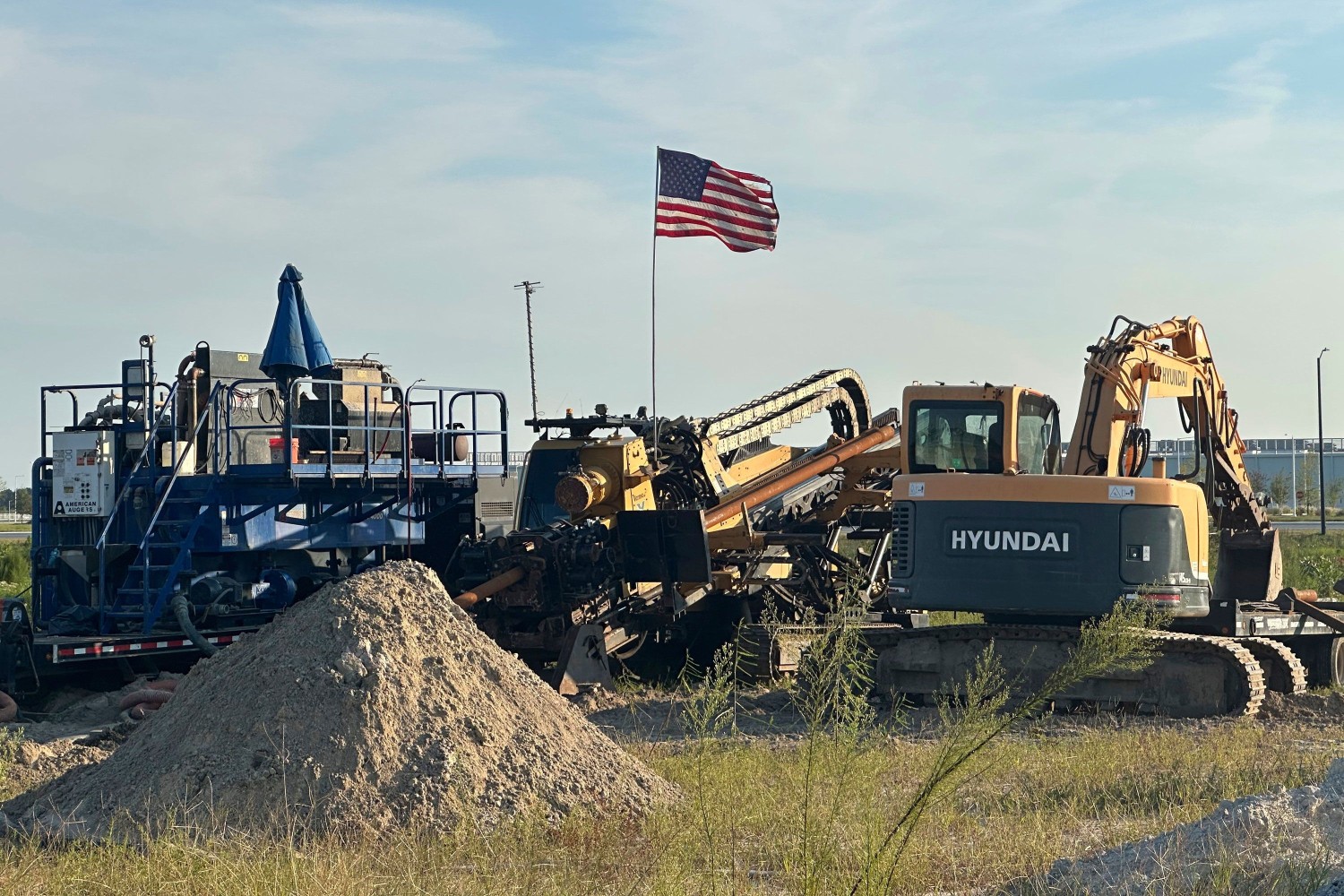 An American flag flies above a piece of heavy machinery at the site of Hyundai Motor Group's electric vehicle plant in Ellabell, Georgia, on Friday. Russ Bynum/AP
