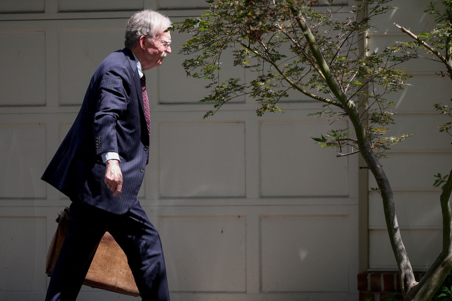 Trump’s former national security adviser John Bolton surrenders to authorities