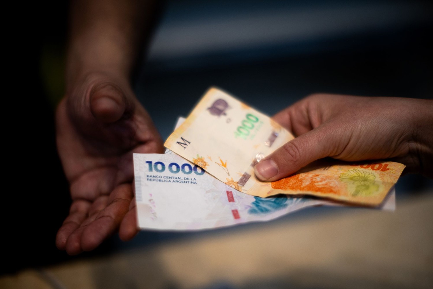 A customer pays for food with Argentine peso banknotes in the financial district of Buenos Aires, Argentina, on September 8, 2025.  Tomas Cuesta/Bloomberg/Getty Images