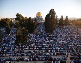 Palestinian Muslim men perform the morning Eid al-Fitr prayer near the Dome of Rock at the Al-Aqsa Mosque compound, Islam's third most holy site, in the old city of Jerusalem on July 6, 2016. Muslims worldwide celebrate Eid al-Fitr marking the e