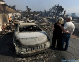 Michael and Vonea McQuillam stand beside their house that was burned to the ground during the Thomas wildfire in Ventura, Calif., on Dec. 5, 2017. Firefighters battled a wind-whipped brush fire in Southern California that has left at least one person
