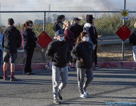 Residents gather on Poe Parkway in Stevenson Ranch, Calif., to watch the Rye Canyon Fire, one of several burning in Southern California.
