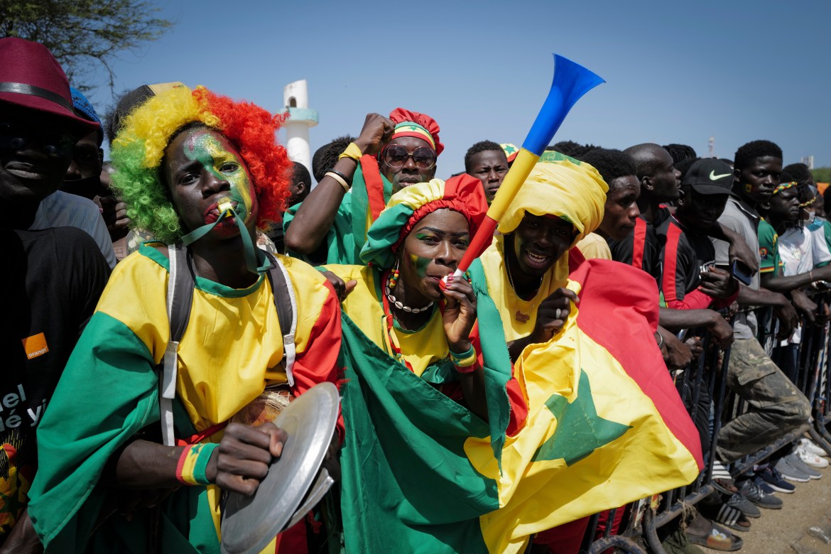 Senegalese fans celebrate ahead of the team's return. Senegal beat Egypt 4-2 on penalties in the final in Yaounde, Cameroon. [Sylvain Cherkaoui/AP Photo]